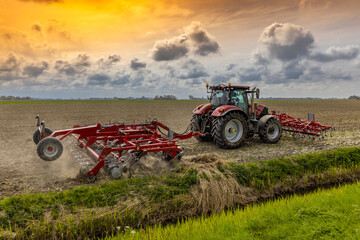Fototapeta premium Tractor during spring work on the field