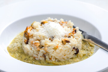 risotto with mussels, sauce and parmesan cheese