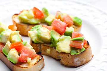 bruschetta with chopped tomatoes and avocado