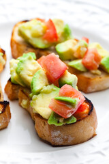 bruschetta with chopped tomatoes and avocado