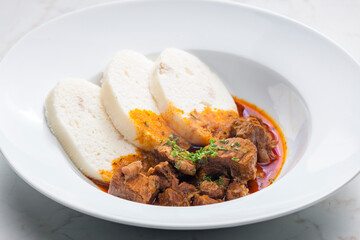 beef goulash served with dumplings