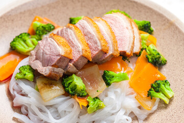 baked duck breast with vegetables and rice noodles
