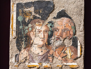 Close-up on colorful ancient roman fresco in ruins decorating house wall in Pompeii showing a...