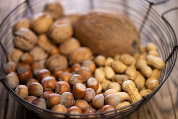 different kinds of nuts on a wooden background