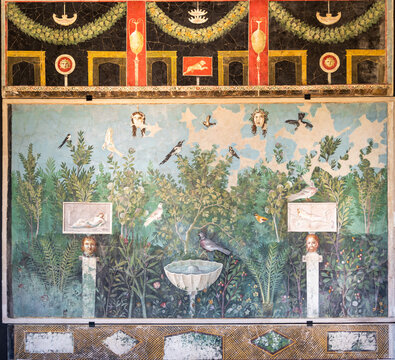Close-up on colorful ancient roman fresco decorating house wall in Pompeii showing human heads exhibited in a garden