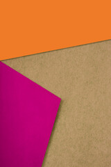 Fototapeta premium Plain and Textured pink yellow bronw papers randomly laying to form M like pattern and triangle for creative cover design idea