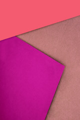 Plain and Textured purple pink peach brown papers randomly laying to form M like pattern and triangle for creative cover design idea