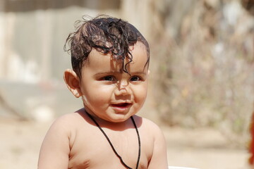 photo of smiling face baby boy with funny expression and without clothes , Pali Rajasthan , India