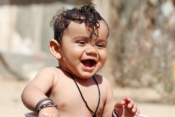 smiling face Adorable baby boy with funny expression and without clothes