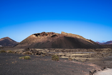 Close photo of the Volcan del Cuervo and the sea of lava solidified around it. Photography made in Lanzarote, Canary Islands, Spain.