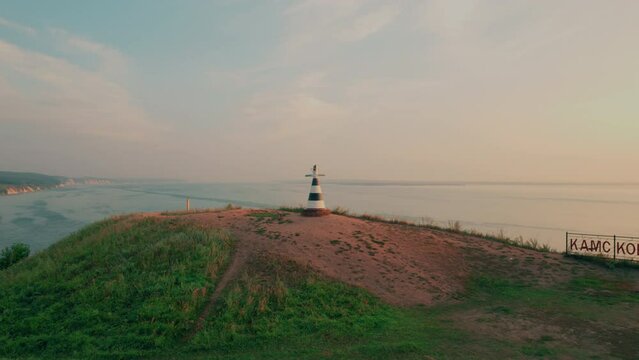 Shot on a drone. Lighthouse with a pointer Volga and Kama. Kama estuary. The confluence of two large rivers. High hilly coast.
