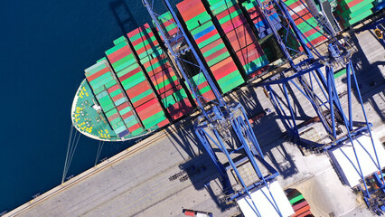 Aerial drone top down photo of container tanker ship anchored in loading - unloading Mediterranean terminal port