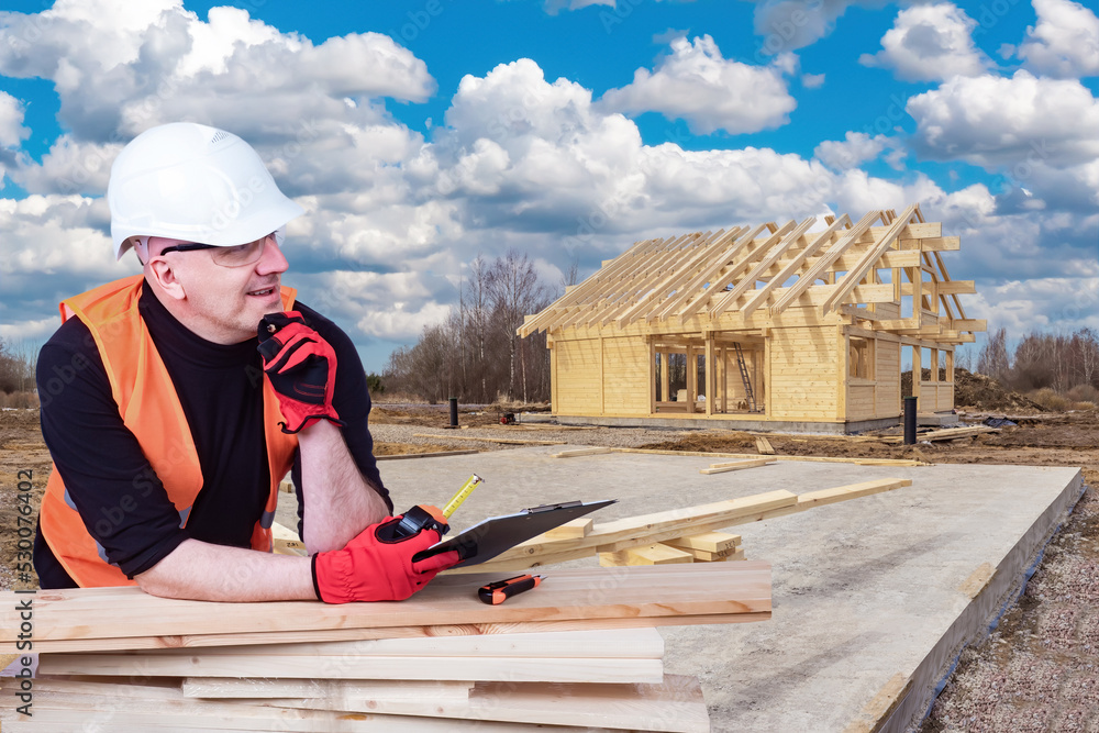 Poster architect near house under construction. man architect thought. builder leaned on boards. frame of c