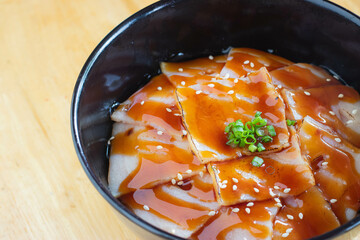 Burnt bacon with teriyaki sauce on Japanese rice. Donburi menu.