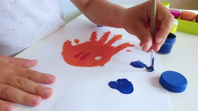 Little child draws a fish, concept of education in the kindergarten