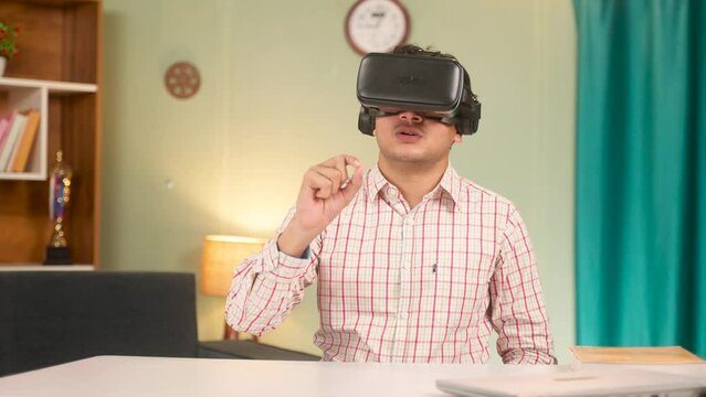 young man planning using VR or vertual reality reality headset in front of empty table - concept of modern technology, cyberspace and futuristic