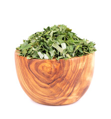 Dry chopped spring onion in wooden bowl, isolated on white background. Dried green onion or scallion. Spices and herbs.