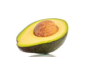 One half of a ripe organic avocado, close-up, isolated on a white background.