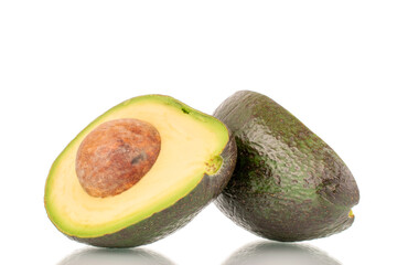 Two halves of a ripe organic avocado, close-up, isolated on a white background.