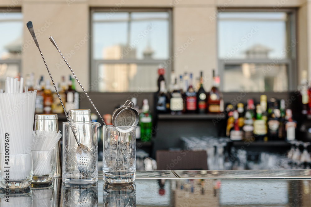 Wall mural glasses for making cocktails on bar counter in modern restaurant