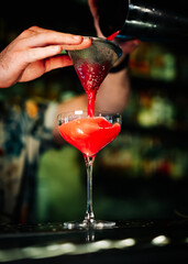 man hand bartender making sweet and sour refreshing cocktail on the bar counter