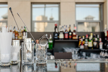 Glasses for making cocktails on bar counter in modern restaurant