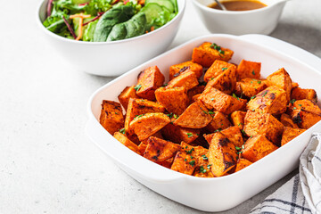 Spicy slices of baked sweet potato. Vegan food concept.