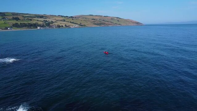 cinematic drone footage following the kayak above the ocean 2.7k