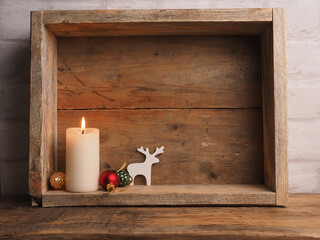 White Advent candles in a wooden box with Christmas decoration and space for text