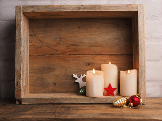 Advent candles in a wooden box with Christmas decoration