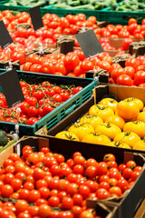 Fresh colourful tomatoes in boxes at market.