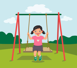 cute little girl swinging and having fun on rope wooden swing in playground