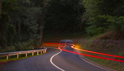 Car lights driving on a curve of the road at night