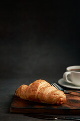 Freshly baked croissants on dark background with copy space