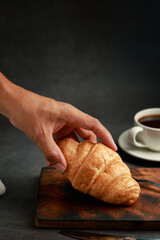 Freshly baked croissants on dark background with copy space