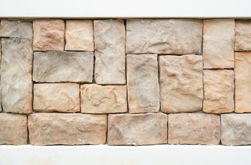 Brown stone wall arranged in a pattern.