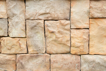 Brown stone walls are arranged in a pattern.