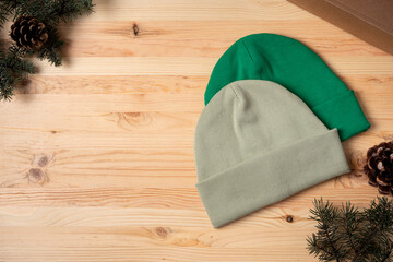 Winter hats on a wooden background with fir branches and cones. Black Friday. Space copy.