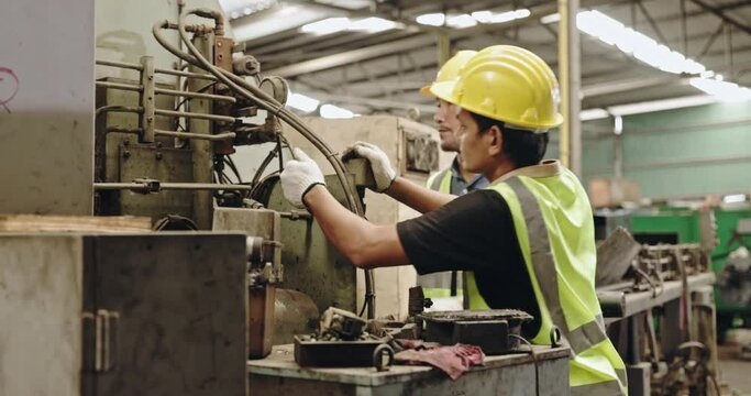 Group of machine technicians are profession inspect the electrical equipment in factory. Industrial plant engineers plan machine maintenance. African American workers work with Asian team Blue collar