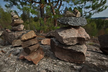 Fototapeta premium Stone pyramids built by tourists on Mount Kuhovuori.