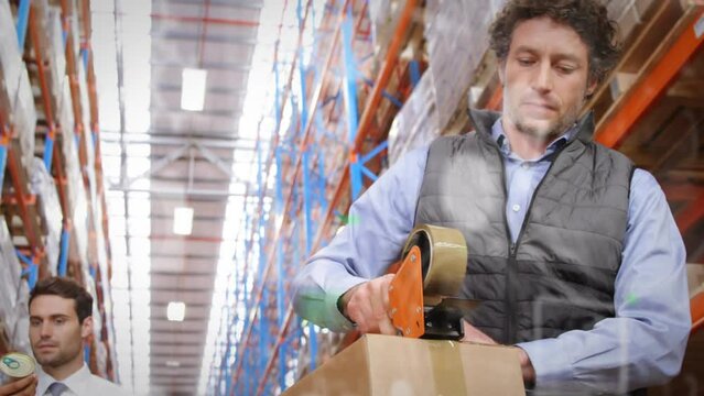 Animation of digital icons over caucasian man working in warehouse