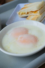 half boiled egg, toasted bread and tea on table 