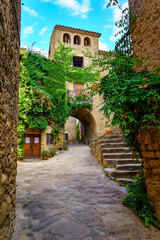 Beautiful and picturesque square with stone arches in the streets and high stairs in Madremanya,...