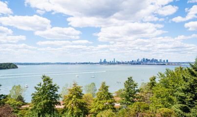 Distant view of the Boston urban cityscape and skyline taken from Spectacle Island during the Summer.