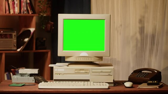 Old computer with green chroma key screen close-up, Desktop PC. Retro room, obsolete technology. 