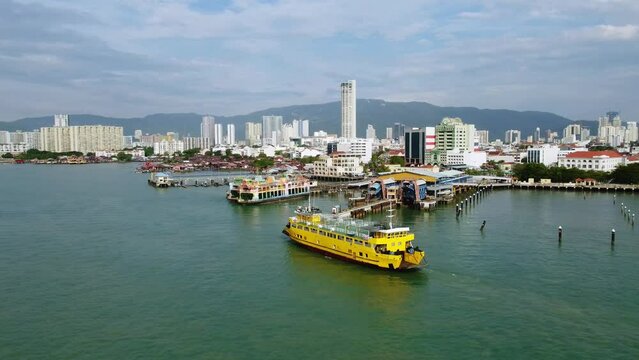 Penang, Malaysia: Aerial drone footage of the RORO car ferry George Town in Penang island toward Butterworth in Malaysia. Shot with a tilt down motion