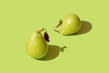 Creative pattern made raw pears on pastel green background with shadow. Healthy food ingredient concept. Minimal style.