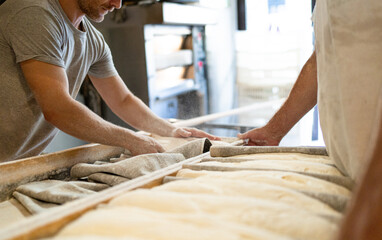 Bakers bring leavened bread to the oven early in the morning, traditional bakery