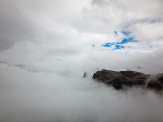 Naklejka na ściany i meble Mountain in clouds in Dolomites Italy