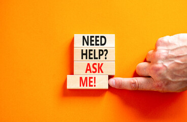Support and need help ask me symbol. Concept words Need help ask me on wooden blocks on a beautiful orange table orange background. Businessman hand. Business, support and Need help ask me concept.